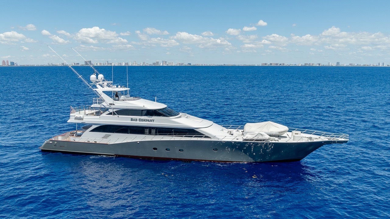 Large sportfishing yacht running offshore under a blue sky
